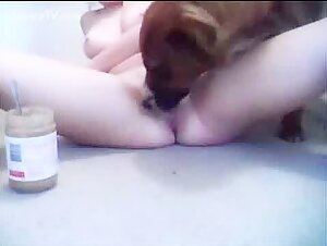 Cute chick puts peanut butter on her pussy and asshole and lets her dog lick